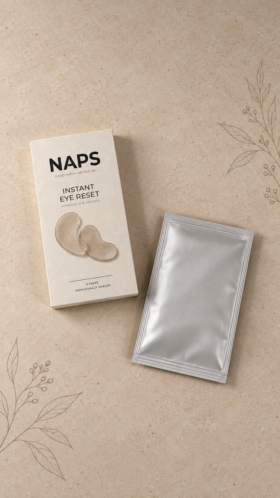 Overhead view of NAPS packaging and a silver sachet on a beige surface with botanical illustrations.