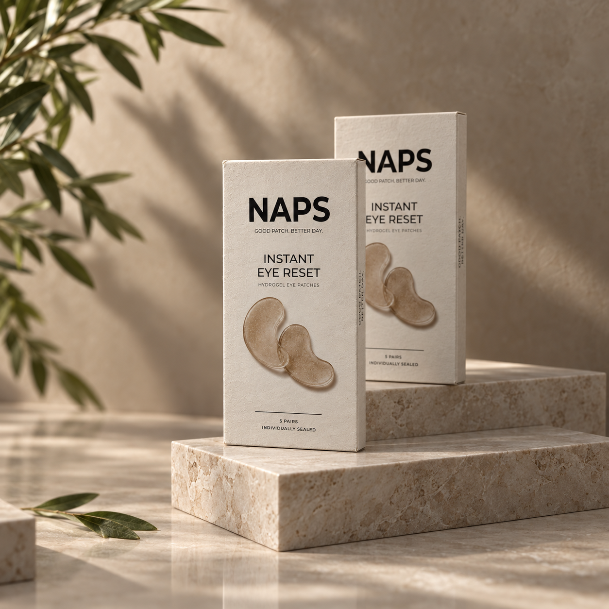 Two NAPS eye patch cartons on stone plinths in warm light, framed by foliage.