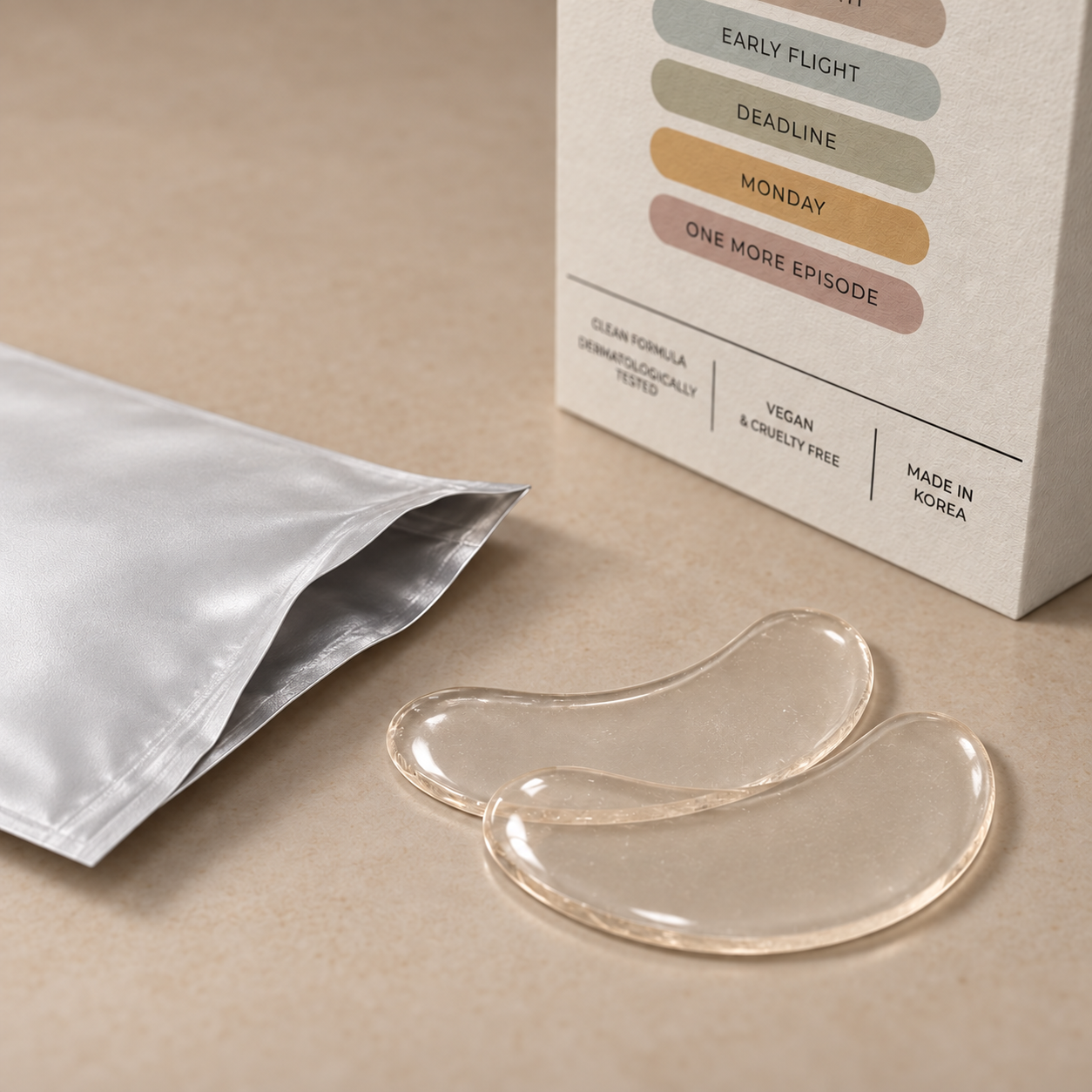Transparent eye patches beside an open silver sachet and textured NAPS packaging.
